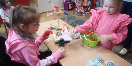 Powiększ grafikę: Przedszkolaki na biurku bawią się zabawkami