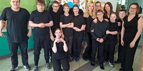 Powiększ grafikę: Grupa teatralna z Osrodka pozuje do zdjęcia, w tle kolorowy wystrój