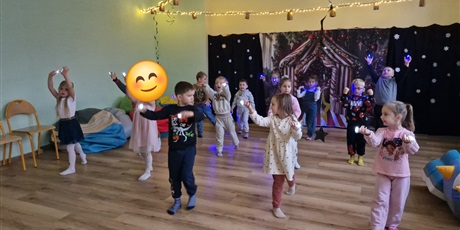 Powiększ grafikę: Dzieci stoją ustawione w  trzech rzędach. 